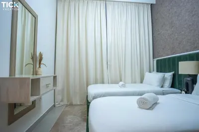 a hotel room with two beds and a mirror at 2BR Luxury Apartment Forte 2 Downtown 14th Floor in Dubai