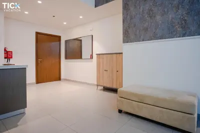 a large living room with a couch and a mirror at 2BR Luxury Apartment Forte 2 Downtown 14th Floor in Dubai