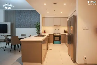a kitchen and dining room with a table and a refrigerator at 2BR Luxury Apartment Forte 2 Downtown 14th Floor in Dubai