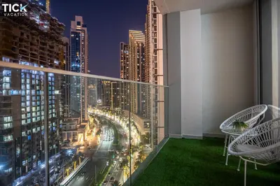 a room with a view of a city at night at 2BR Luxury Apartment Forte 2 Downtown 14th Floor in Dubai