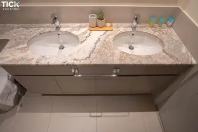 a bathroom with two sinks in a marble counter top at 2BR Luxury Apartment Forte 2 Downtown 14th Floor in Dubai