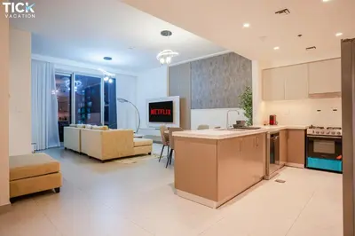 a kitchen and living room with a couch and a table at 2BR Luxury Apartment Forte 2 Downtown 14th Floor in Dubai