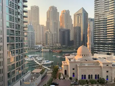 a view of a city with a building and a river at Dubai Marina-short stay in Dubai