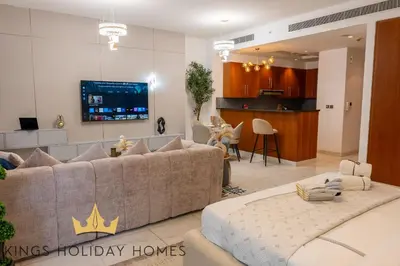 a living room with a couch and a tv at Central Park towers Difc Royal suite kings in Dubai