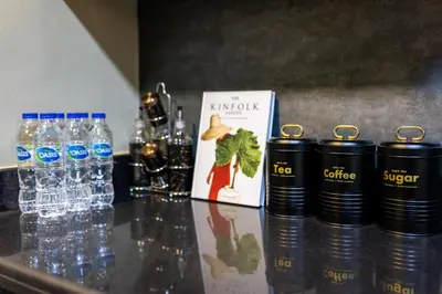 a counter with bottles of water and a book at Dubai Eye and Sunset Views 1 Bedroom Apartment with Direct Beach Access, Gym, and Pool in Dubai