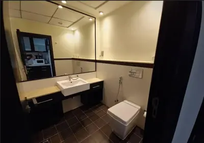 a bathroom with a toilet and a sink and a mirror at Well located Studio on 9 floor Sky View Tower in Dubai
