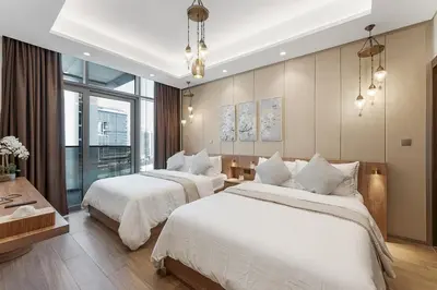 two beds in a hotel room with white sheets at Amazing 1BR Apt in Business Bay - Nobles Tower - Close to Dubai Mall in Dubai