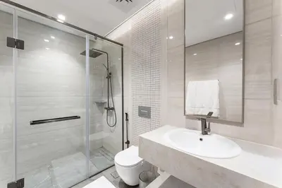 a bathroom with a shower and a sink and a toilet at Amazing 1BR Apt in Business Bay - Nobles Tower - Close to Dubai Mall in Dubai