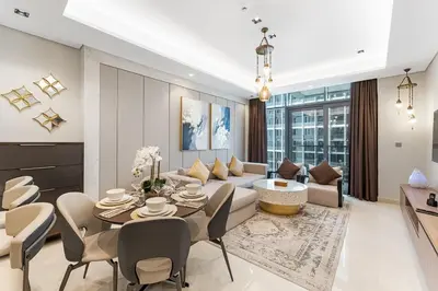 a living room with a couch and a table at Amazing 1BR Apt in Business Bay - Nobles Tower - Close to Dubai Mall in Dubai