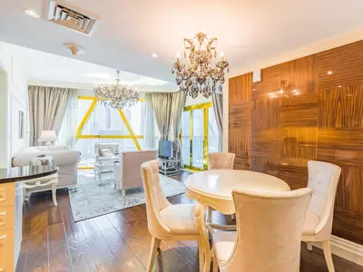 a dining room with a table and chairs at Luxury Spacious Condo in the Iconic Park Towers in Dubai