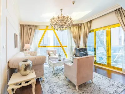 a living room with a couch and chairs and a chandelier at Luxury Spacious Condo in the Iconic Park Towers in Dubai