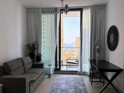 a living room with a couch and a table at Luxury Sea View Studio in Dubai Marina in Dubai