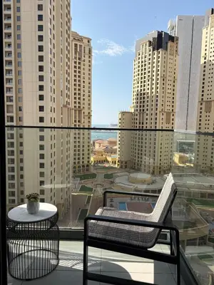 a balcony with a view of a city with tall buildings at Luxury Sea View Studio in Dubai Marina in Dubai