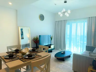 a living room with a table and a couch at INA HOMES - Burj Royal 1 BR Stylish Apartment in Dubai