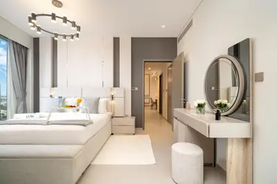 a bedroom with a bed and a sink and a mirror at Luxe Living at Grande Signature - Burj Khalifa and Sea Views - Brand New in Dubai