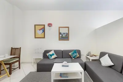 a living room with a couch and a table at ALiving Cozy Studio with Balcony I Marina Pearl- 407 in Dubai