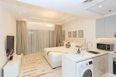a hotel room with a bed and a kitchen at Stylish Studio 5 min Walk to Mall & Burj Khalifa in Dubai