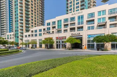 a street in front of a building with tall buildings at Stylish Studio 5 min Walk to Mall & Burj Khalifa in Dubai