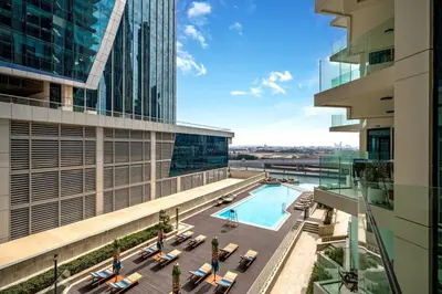 an overhead view of a building with a swimming pool at Sunset serenity - Urban Oasis Business Bay in Dubai