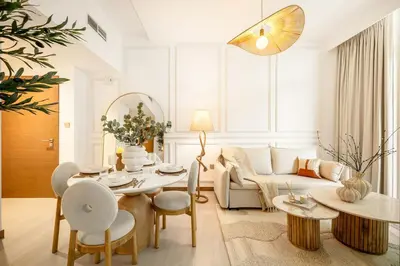 a living room with a table and a couch at Sunset serenity - Urban Oasis Business Bay in Dubai