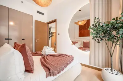 a bedroom with a bed and a mirror at Sunset serenity - Urban Oasis Business Bay in Dubai