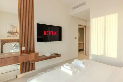 a bedroom with a bed with a tv on the wall at 60th High Floor - full World islands, Downtown and Ocean View - high quality Design and Furniture - 2 Bedroom in Dubai