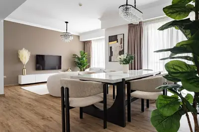 a living room with a dining room table and chairs at 1 bedroom Apartment in JBR in Dubai
