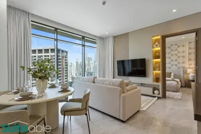 a living room with a couch and a table at Stunning 1 Bedroom with Burj Khalifa view in Dubai