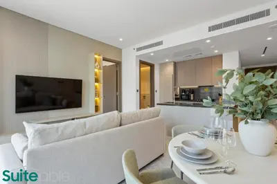 a living room with a couch and a table at Stunning 1 Bedroom with Burj Khalifa view in Dubai