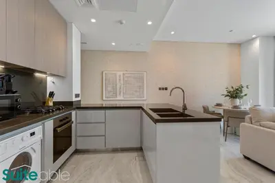 a kitchen with a sink and a stove top oven at Stunning 1 Bedroom with Burj Khalifa view in Dubai