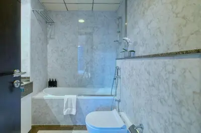 a bathroom with a toilet and a bath tub at High floor Marina Views Walk to Beach JBR & Mall in Dubai