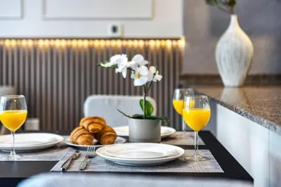 a table with plates and glasses of orange juice and croissants at High floor Marina Views Walk to Beach JBR & Mall in Dubai