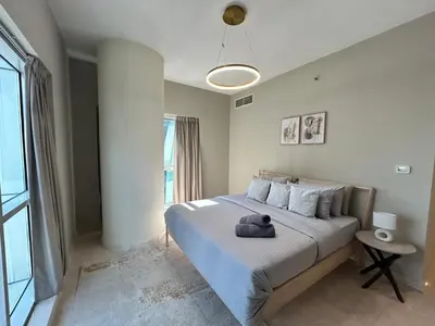 a bedroom with a bed with a stuffed animal on it at Spacious 1BHK Apartment, Near City centre in Dubai