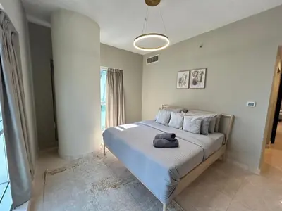 a bedroom with a bed with a stuffed animal on it at Spacious 1BHK Apartment, Near City centre in Dubai