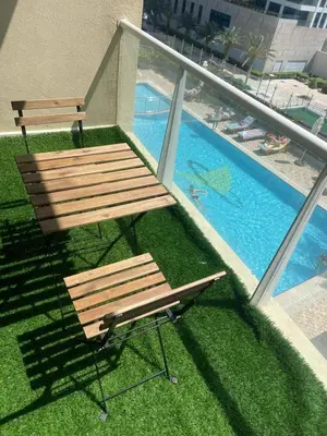 a bench next to a swimming pool on top of a building at Ultra Luxury Chic Studio in JLT in Dubai