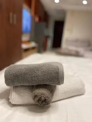 a pile of towels sitting on top of a bed at Ultra Luxury Chic Studio in JLT in Dubai