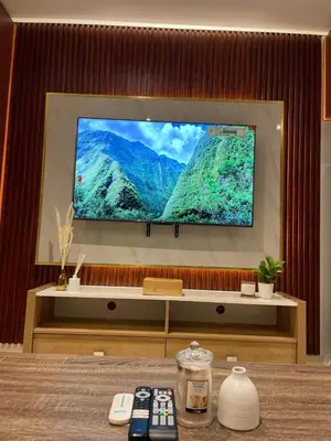 a flat screen tv on a wall with remote controls at Ultra Luxury Chic Studio in JLT in Dubai