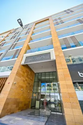 a building with a sign on the side of it at Cozy Studio with Balcony in Azizi Riviera and 10 Mins to Burj Khalifa in Dubai