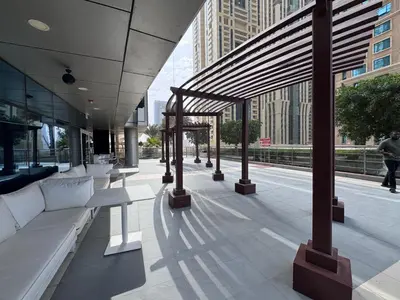 a building with white couches on a city street at Elegant 1BR in Ocean Heights in Dubai