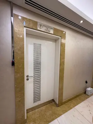 a white elevator door with a sign on it at Elegant 1BR in Ocean Heights in Dubai