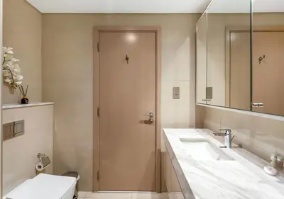 a bathroom with two sinks and a toilet and a mirror at Luxury 3 BR Full Burj Khalifa and Fountain View in Dubai