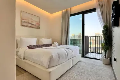 a bedroom with a large bed and a large window at Vserve Modern Oasis Canal & Burj Views in Dubai