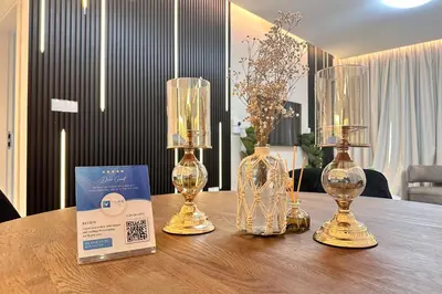 a table with three wine glasses and a box on it at Vserve Modern Oasis Canal & Burj Views in Dubai