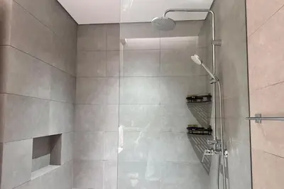a bathroom with a shower with a glass door at Vserve Modern Oasis Canal & Burj Views in Dubai