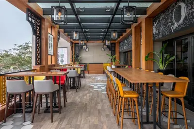an empty restaurant with wooden tables and chairs at Hyatt Regency Creek Heights Residences in Dubai