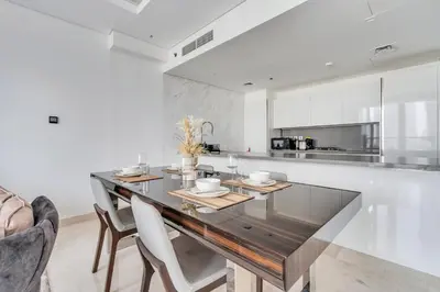 a dining room with a glass table and chairs at New Luxury 1BR Apart Business Bay with Balcony in Dubai
