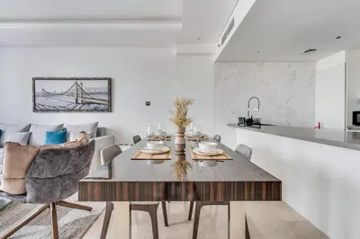 a dining room and kitchen with a table and chairs at New Luxury 1BR Apart Business Bay with Balcony in Dubai