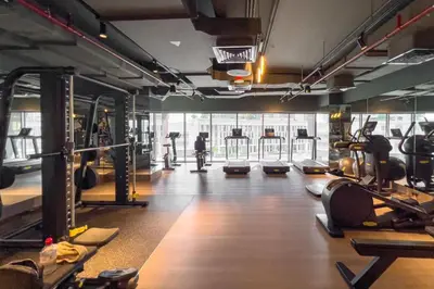 a gym with lots of treadmills and machines at New Luxury 1BR Apart Business Bay with Balcony in Dubai