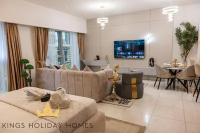 a living room with couches and a dining room at Central Park towers Difc suite kings in Dubai