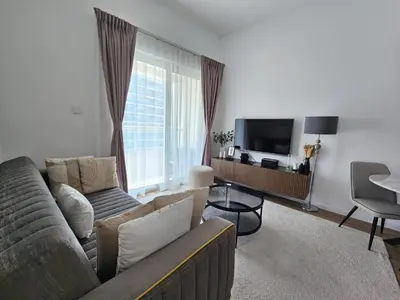 a living room with a couch and a television at Marina Water Residence in Dubai